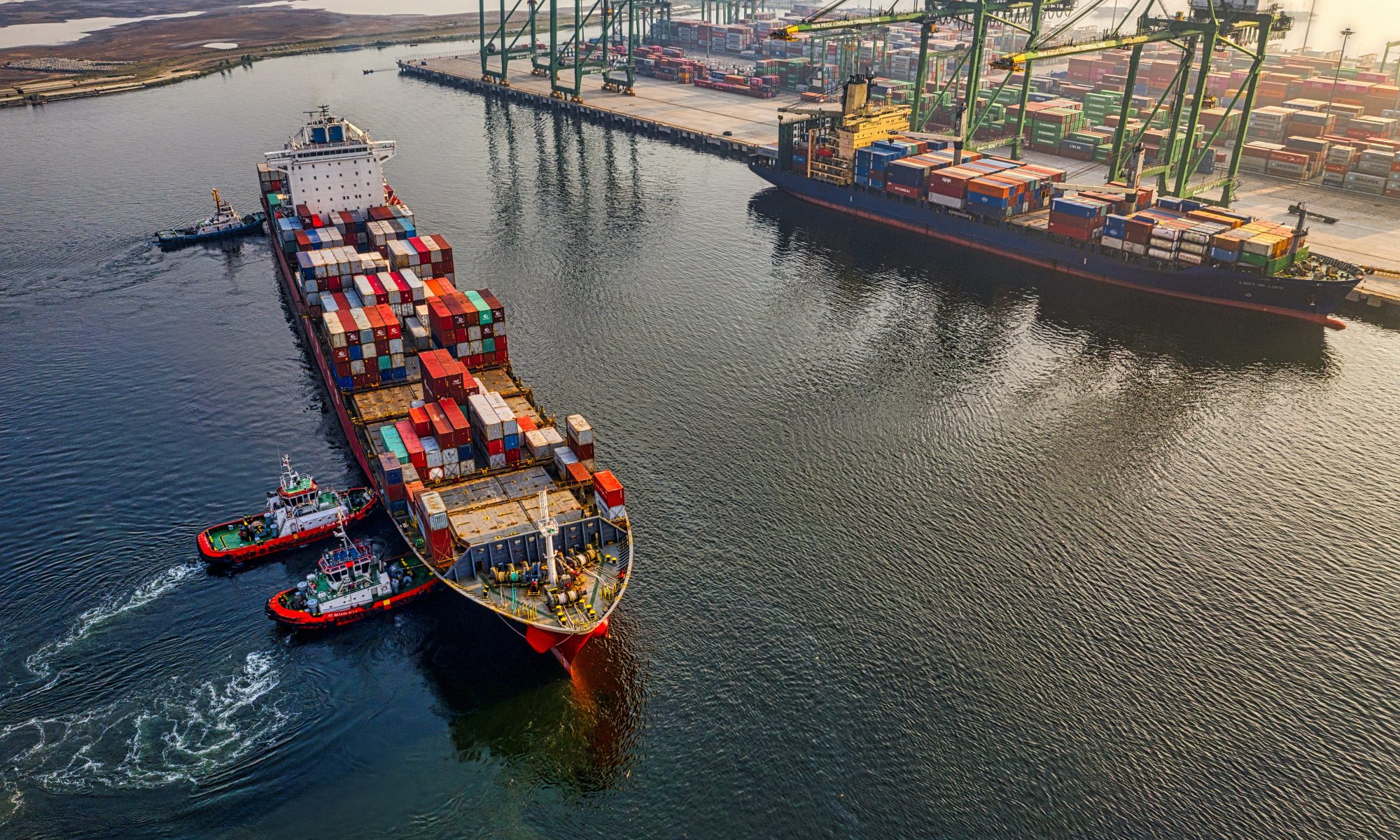An image showing a cargo ship near a port